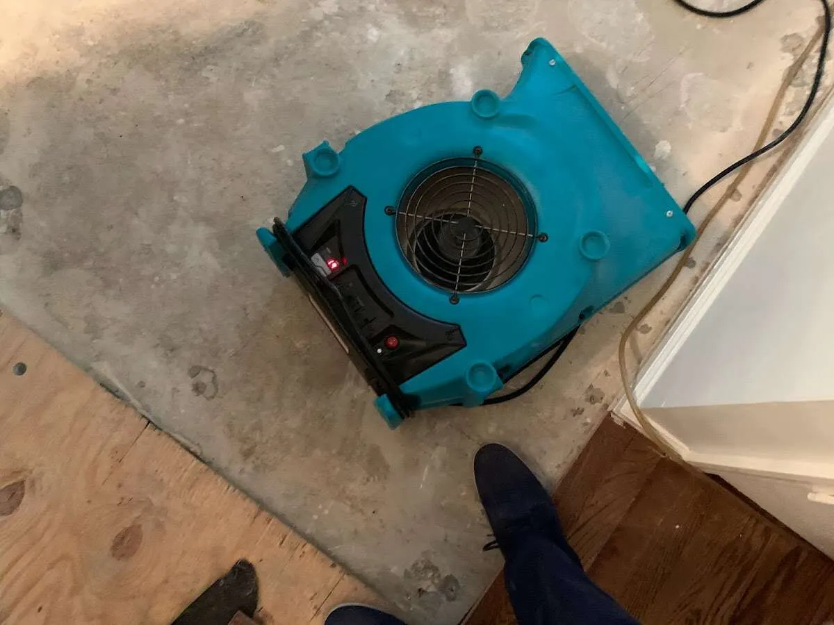 Air mover drying subfloor during Commercial Water Damage Restoration in West Milford